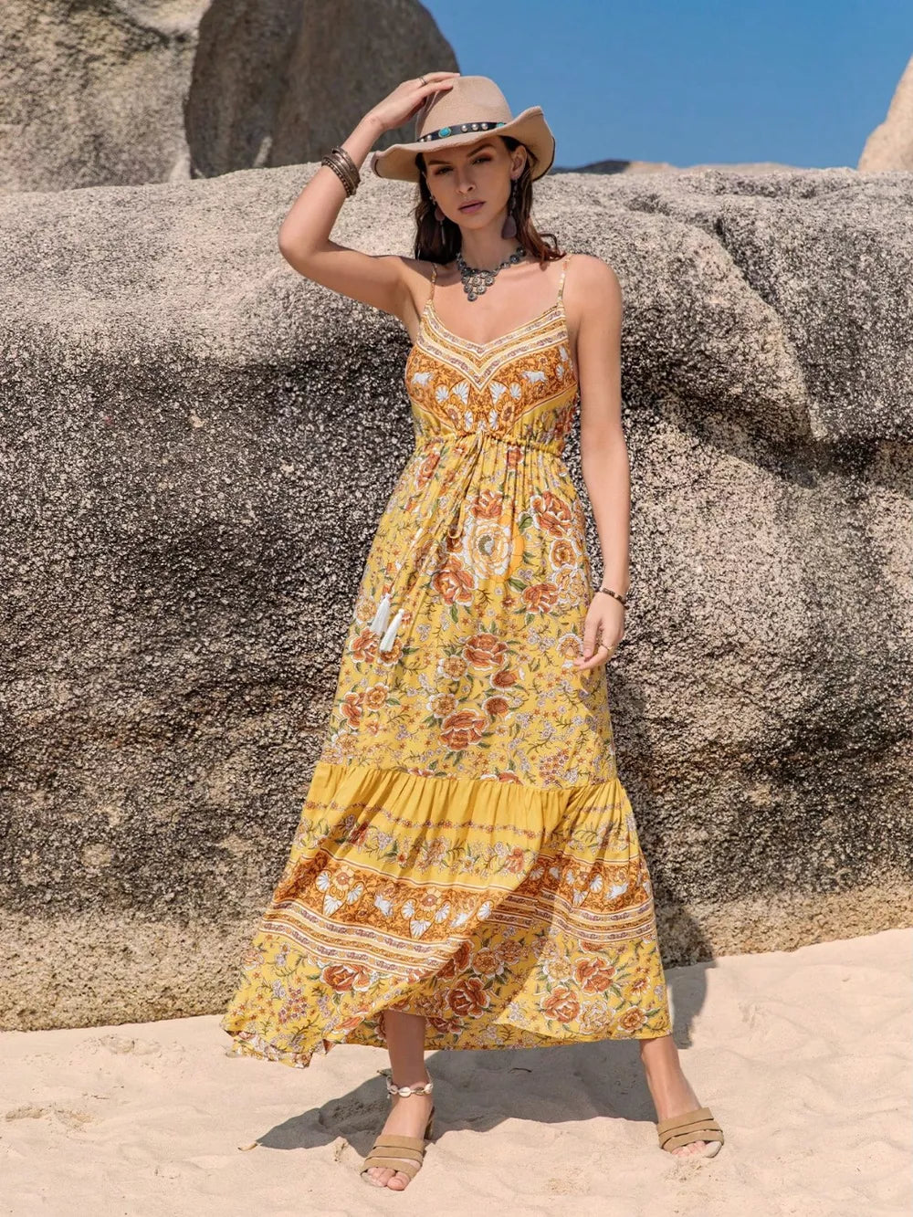 Yellow floral tiered cami maxi dress with tassels and V-neckline.