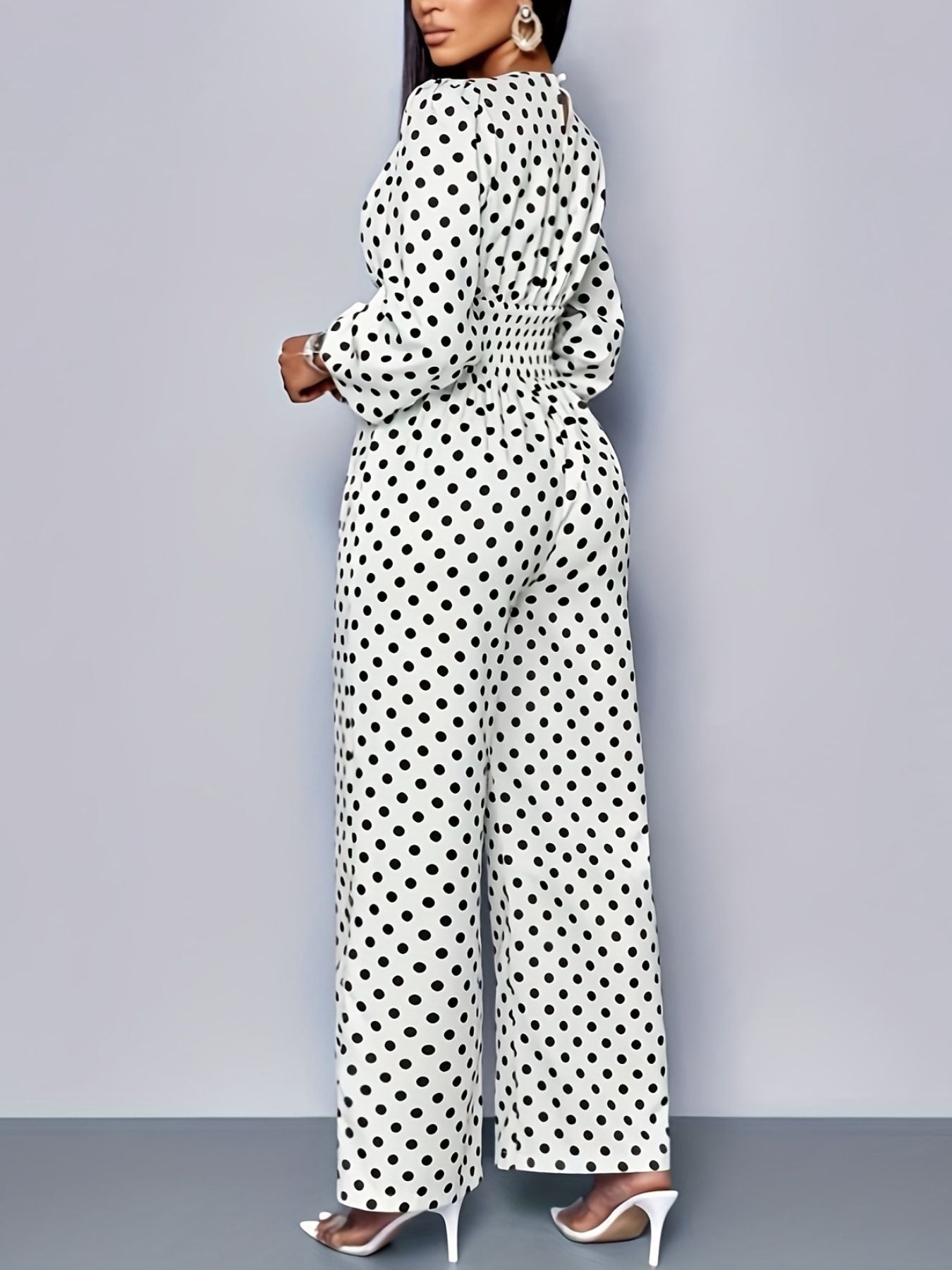 Chic white polka dot wide-leg jumpsuit with balloon sleeves and smocked waist.