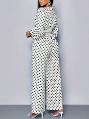 Chic white polka dot wide-leg jumpsuit with balloon sleeves and smocked waist.