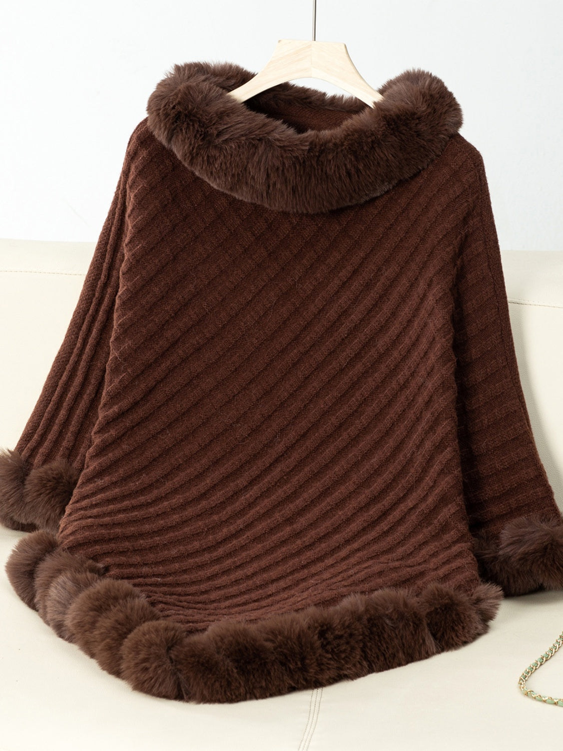 Chocolate knit poncho with faux fur trim at neckline and hem