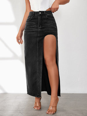 Black washed denim maxi skirt with a high slit, styled with clear heels.