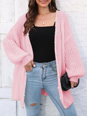 Blush pink balloon sleeve cardigan with pearl buttons, open front, and textured knit.