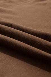 Coffee brown relaxed fit lounge set fabric detail with soft texture and draped folds.