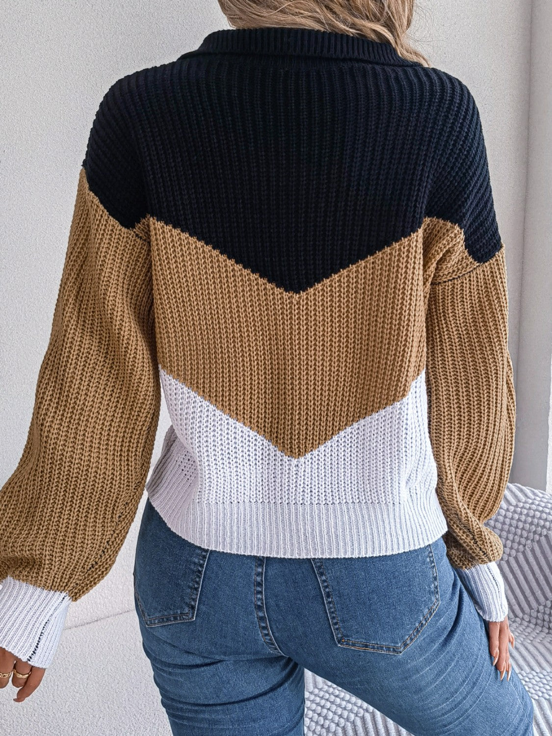Chevron block knit polo sweater in camel, black, white, and gray acrylic with a collared neckline.