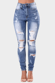 Light wash ripped knee skinny jeans with button fly and sculpting fit
