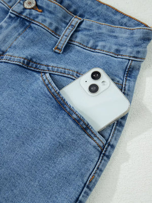 Blue denim shorts with a phone in the pocket, featuring button closure and contrast stitching.