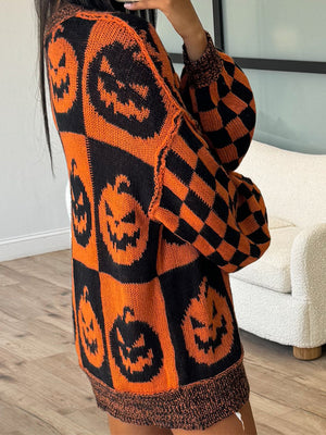 Checkerboard pumpkin knit sweater with balloon sleeves in ochre and black.