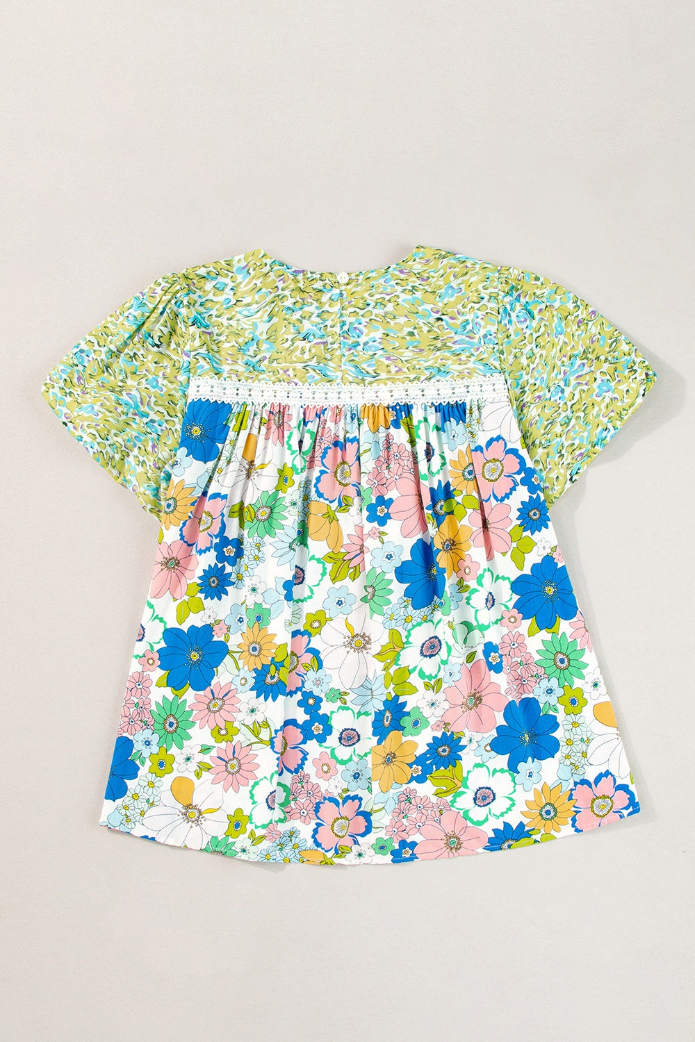 Floral patchwork puff sleeve blouse with smocked detail and white lace trim.