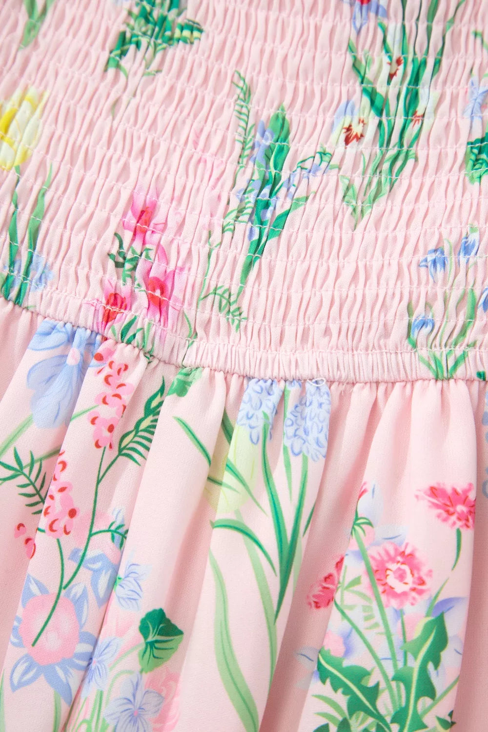 Pink midi dress with smocked bodice and wildflower print.