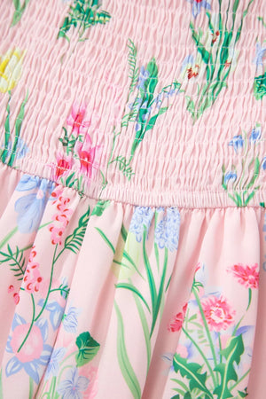 Pink midi dress with smocked bodice and wildflower print.