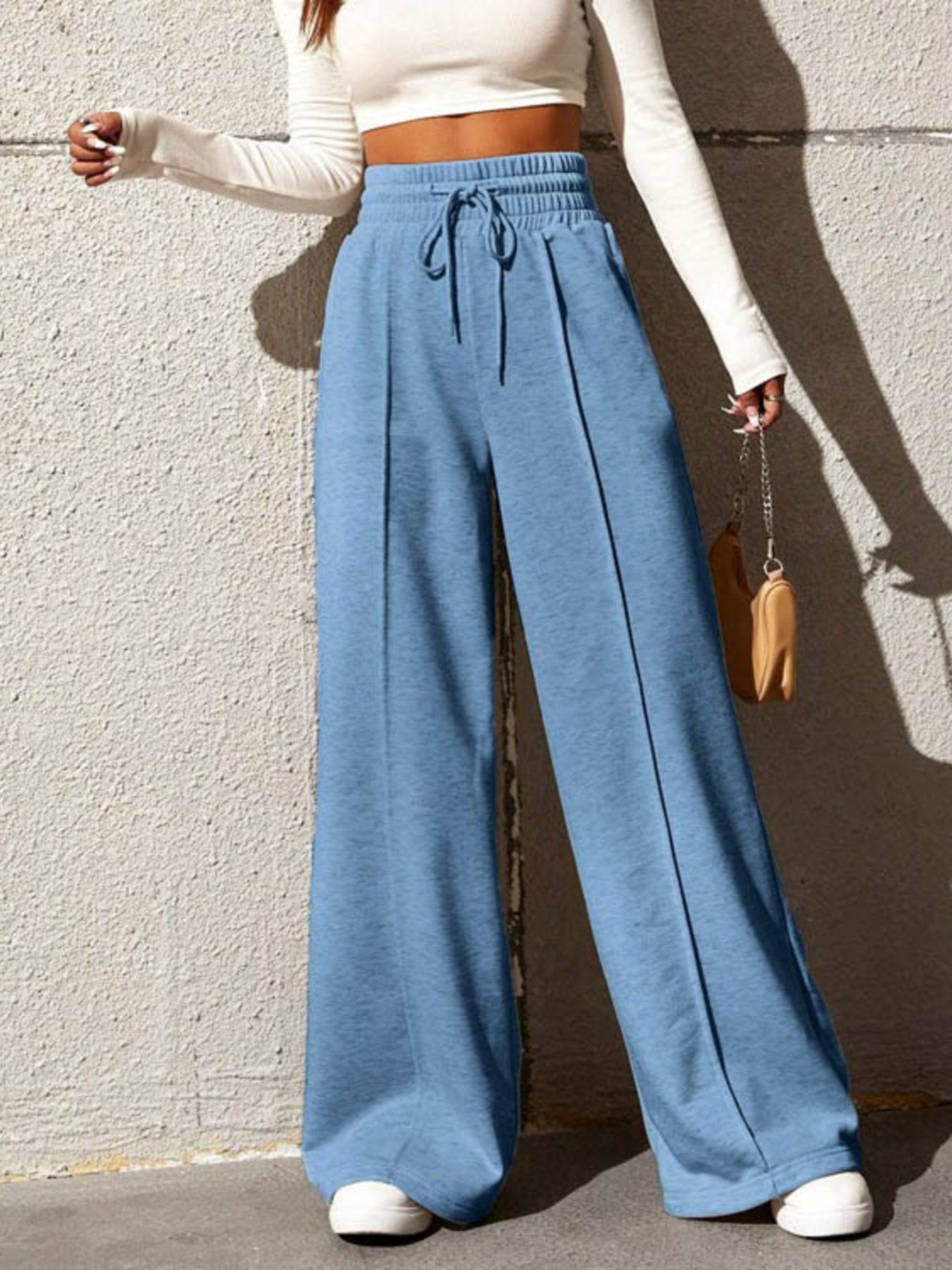 Sky blue wide-leg sweatpants with drawstring waist and front seam detail.