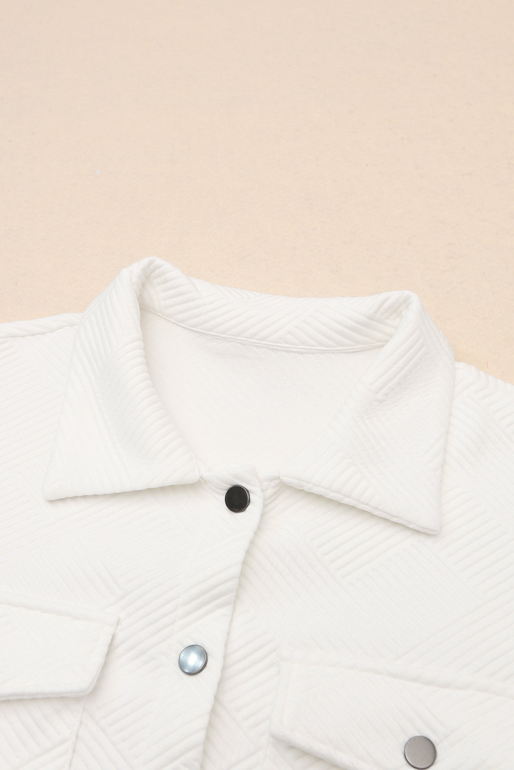 Textured ivory overshirt with patch pockets and button details.