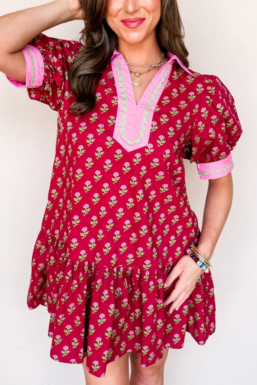 Red floral mini dress with V-neck, puff sleeves, and ruffled hem.