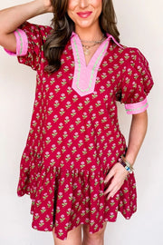 Red floral mini dress with V-neck, puff sleeves, and ruffled hem.
