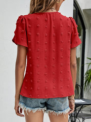 Red textured puff sleeve blouse with dot pattern and short sleeves.