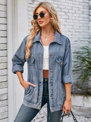 Oversized denim trucker jacket in dusty blue with rolled sleeves and button details.