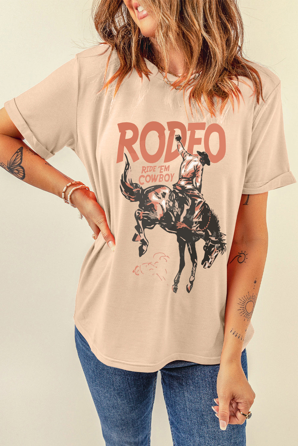 Tan graphic t-shirt with a rodeo cowboy riding a bucking bronco and "RODEO RIDE 'EM COWBOY" text.