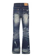 Distressed dark wash flare jeans with pocket details and button fly.