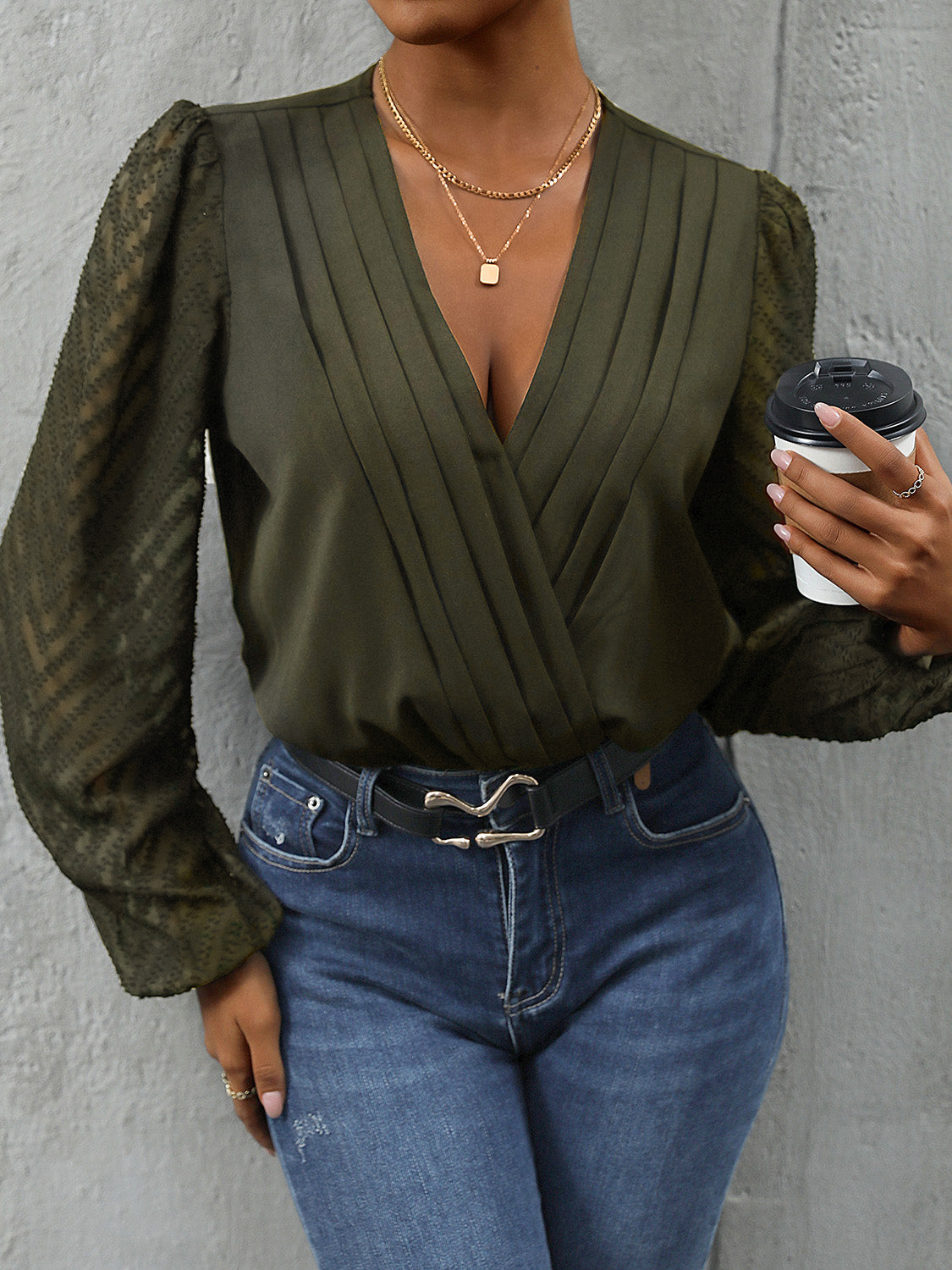 Matcha green bodysuit with plunge neckline, pleated front, and sheer chevron sleeves.