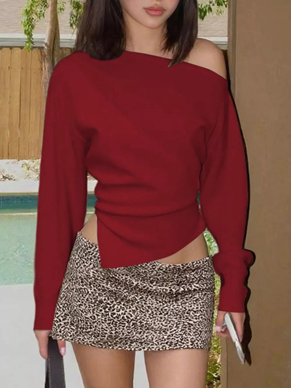 Red draped asymmetrical off-shoulder t-shirt with a unique side slit detail.
