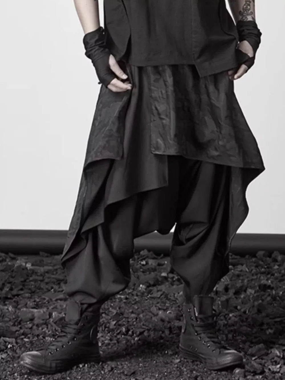 Black avant-garde layered harem sweatpants with asymmetrical design and dropped crotch.