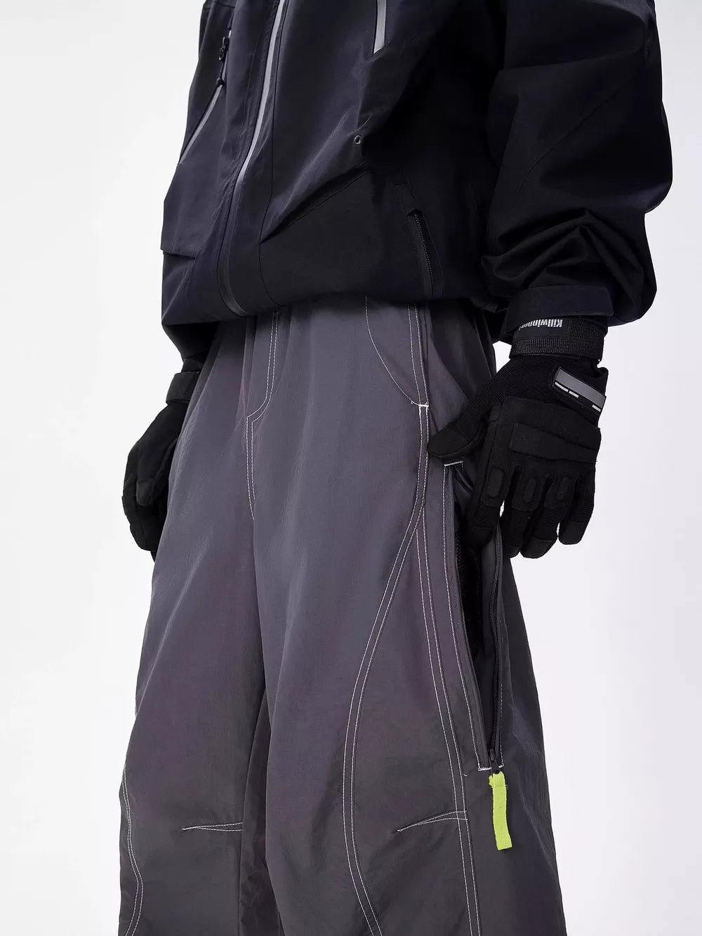Men's gray cargo sweatpants with contrast stitching and zippered pockets.