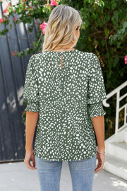 Dark blue blouse with white spot print and shirred sleeves.