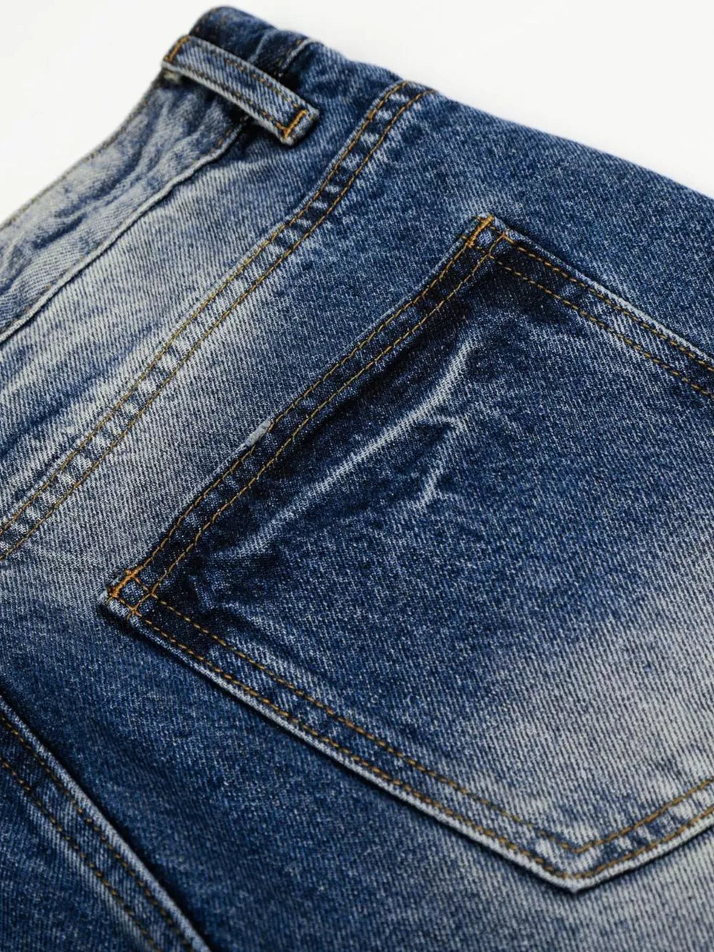 Men's light blue vintage wash wide leg jeans, close-up of back pocket detail.