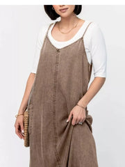 Brown washed denim maxi dress with V-neck and adjustable straps, layered over a white tee.