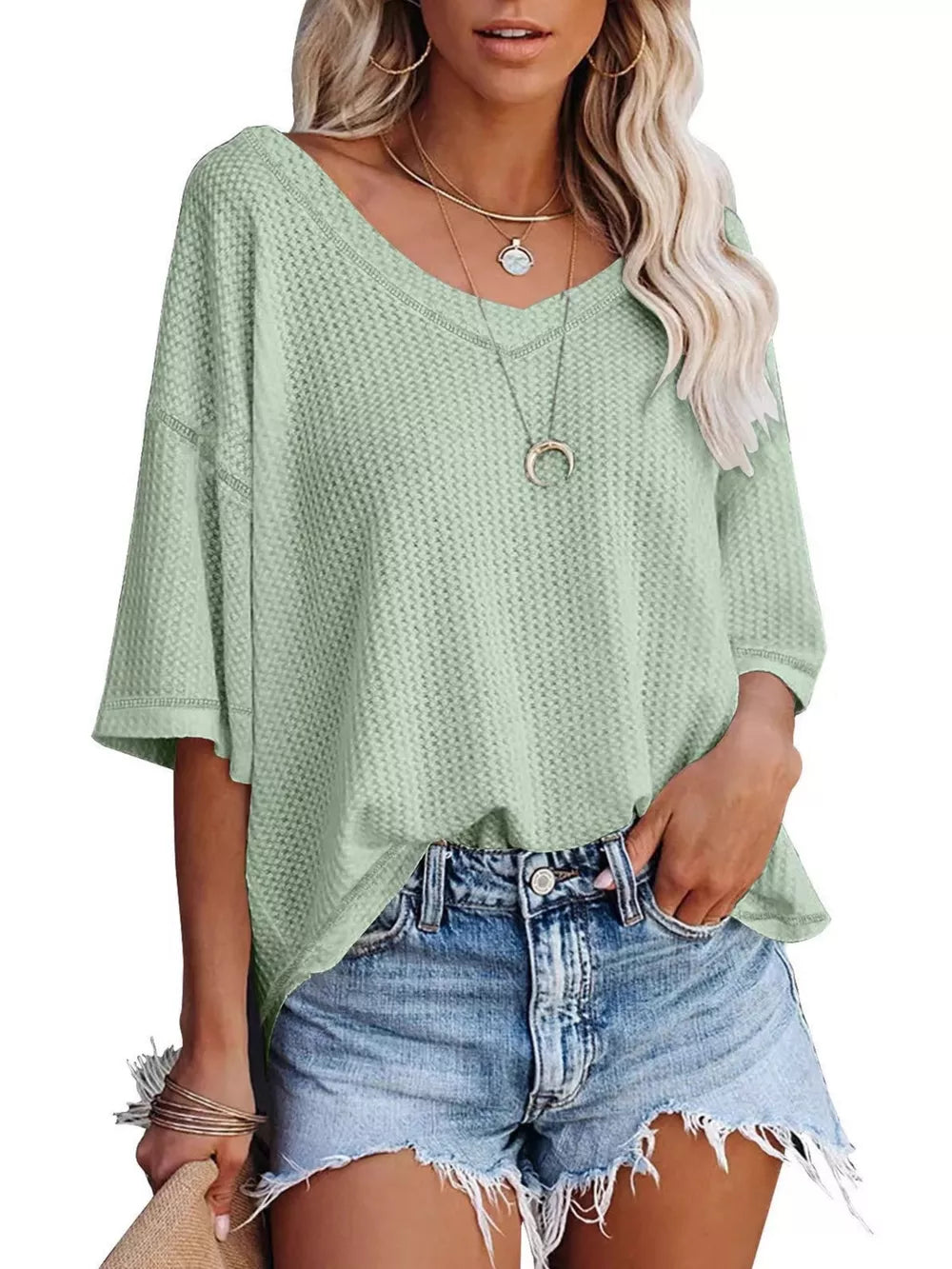 Light Green waffle knit relaxed V-neck t-shirt with short sleeves, styled with denim shorts.