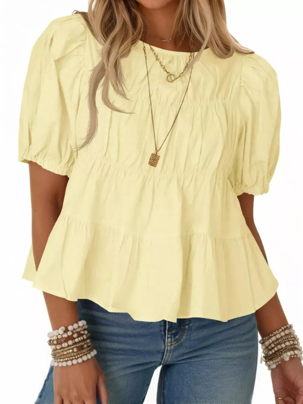 Light yellow maternity blouse with puff sleeves, smocked bodice, and tiered ruffled hem.