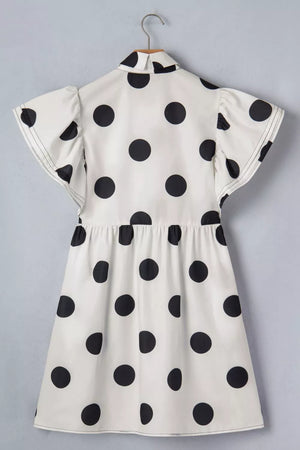 Black and white polka dot mini dress with ruffled sleeves and collared neckline.