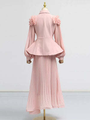 Pink two-piece skirt suit with frill collar, balloon sleeves, peplum jacket, and pleated midi skirt.