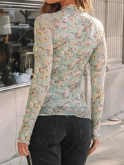 Light green floral mesh second-skin top with mock neck and lettuce trim sleeves.