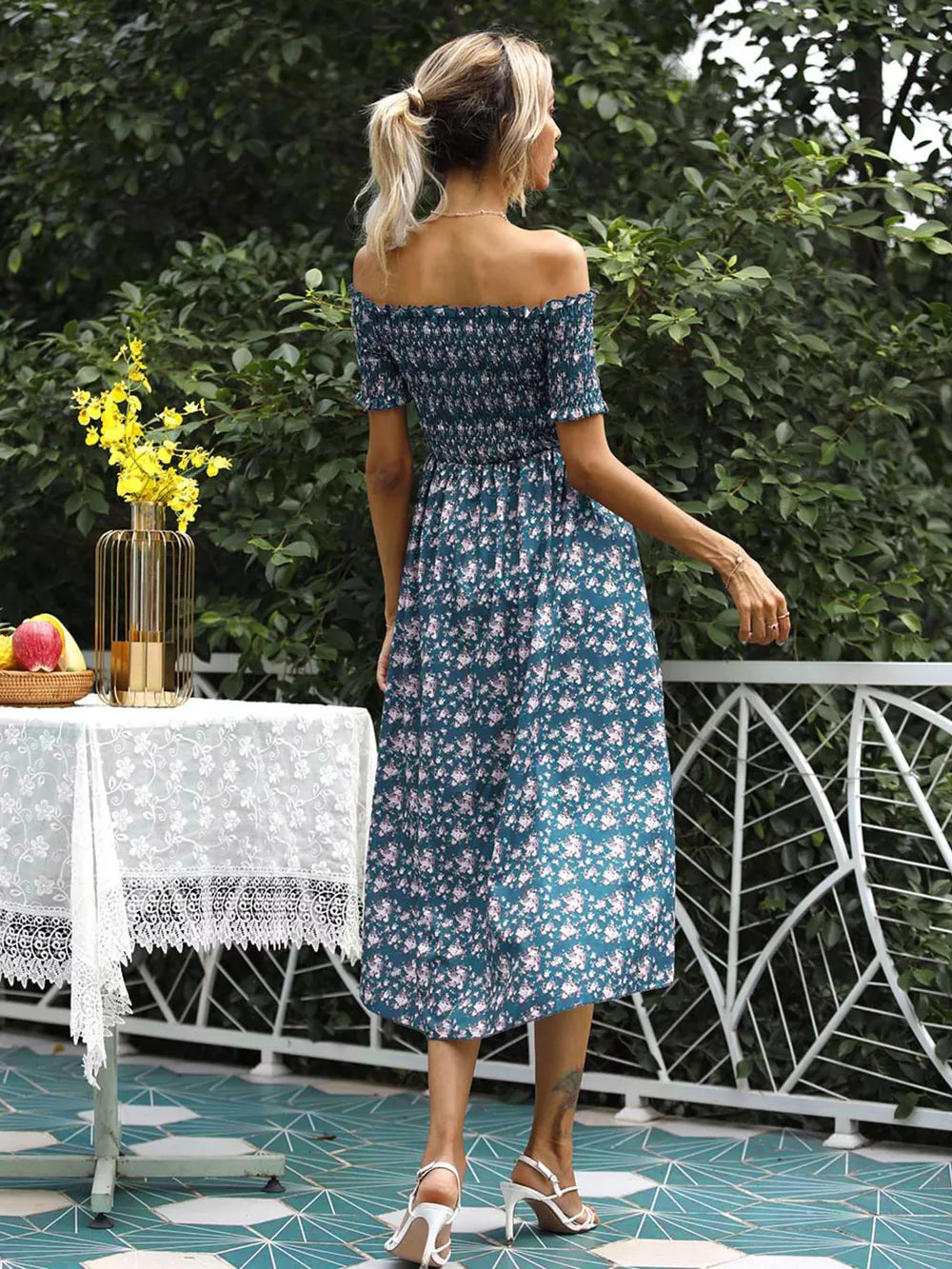 Floral off-shoulder midi dress in deep teal with smocked bodice and side slit.