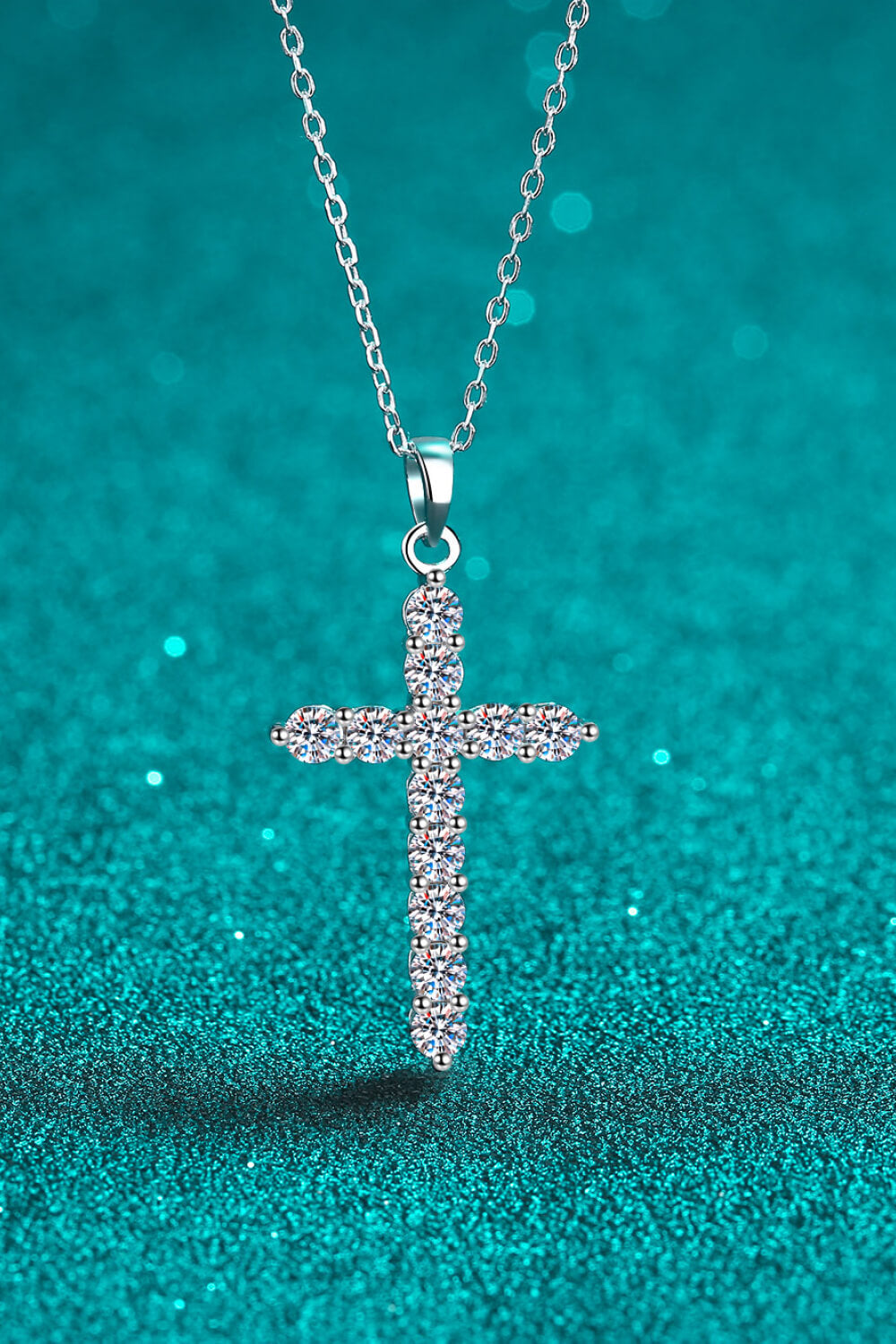 Silver pavé diamond cross pendant necklace with a delicate chain.