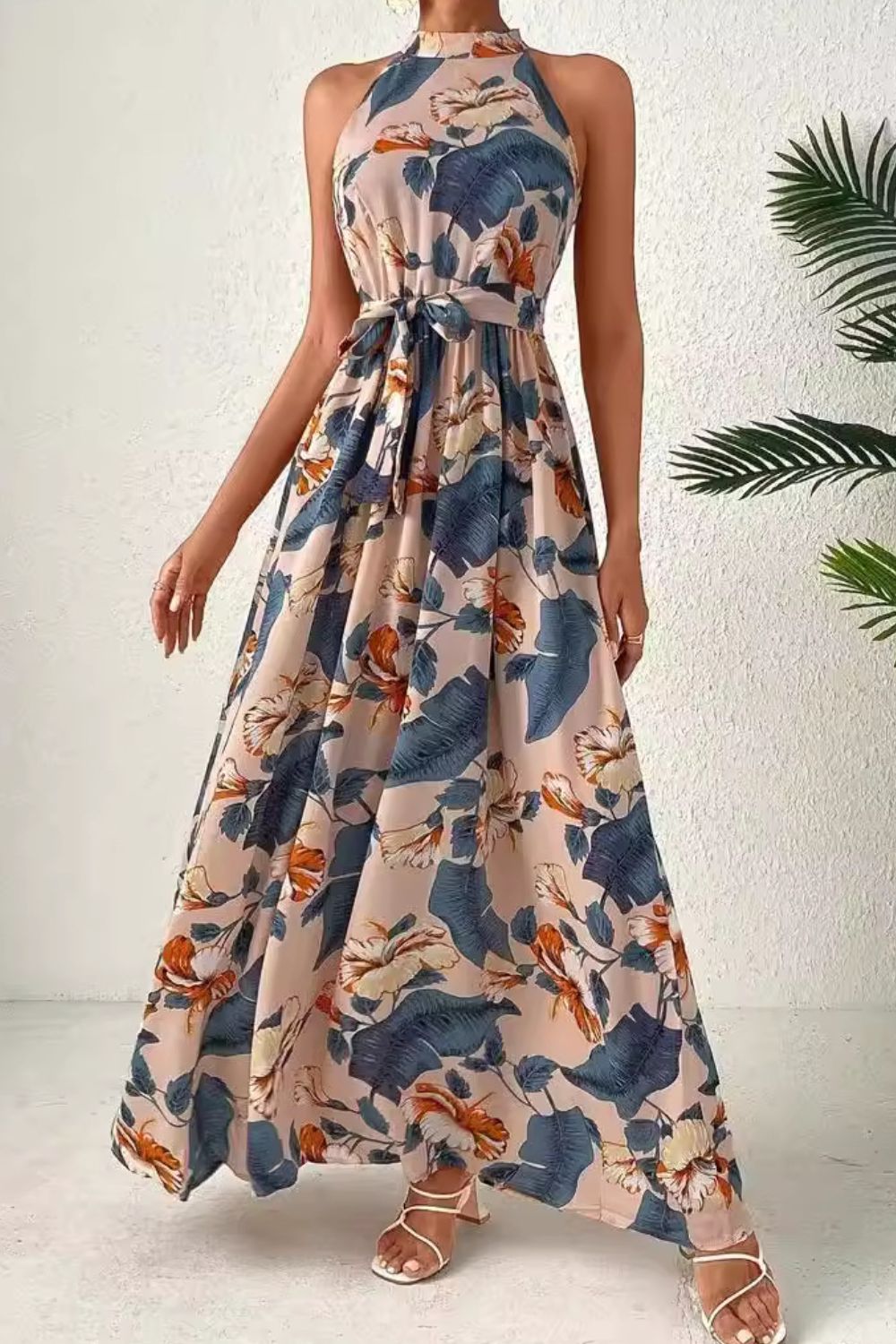 Halter neck maxi dress with floral paisley print and tie waist in tan and blue.
