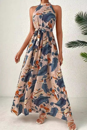 Halter neck maxi dress with floral paisley print and tie waist in tan and blue.