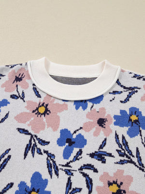Patchwork sweater with floral design in pink and blue, featuring a white ribbed crew neck.