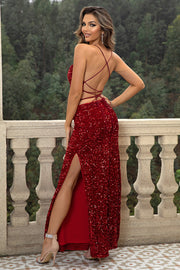 Crimson sequin backless gown with spaghetti straps and a high slit.