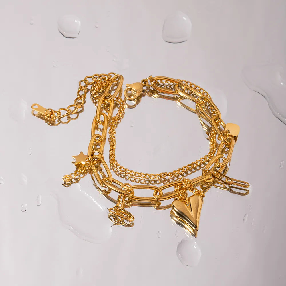 Gold layered chain bracelet with star and heart charms