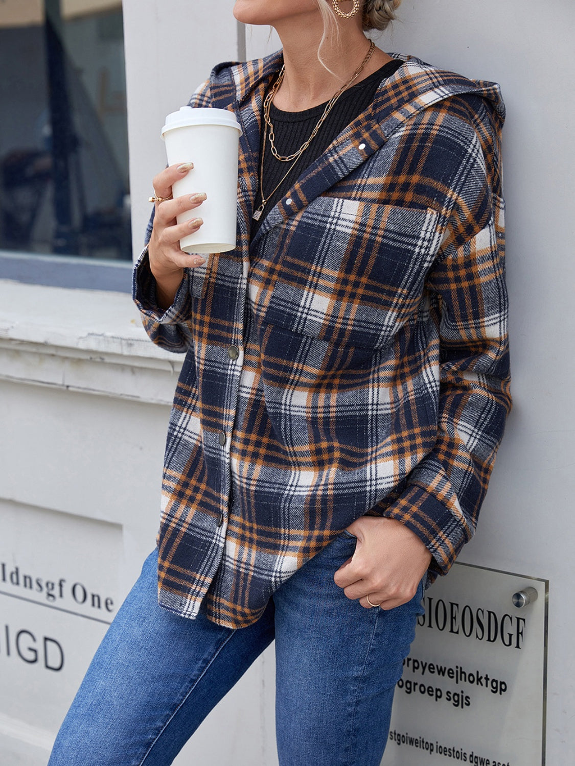 Plaid hooded shacket in navy and brown with button front and relaxed fit.
