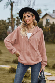 Textured cable knit zip-up hoodie in dusty pink with a relaxed fit and front pockets.