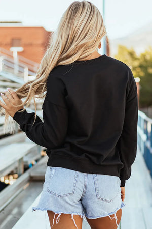 Black crewneck sweatshirt with baseball script appliqué detail.
