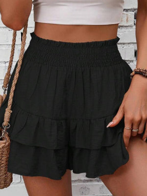 Black tiered ruffle skort with smocked waist, 100% polyester.