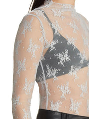 White floral lace illusion mock neck blouse with long sleeves.
