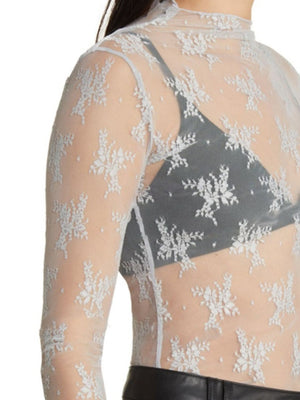White floral lace illusion mock neck blouse with long sleeves.