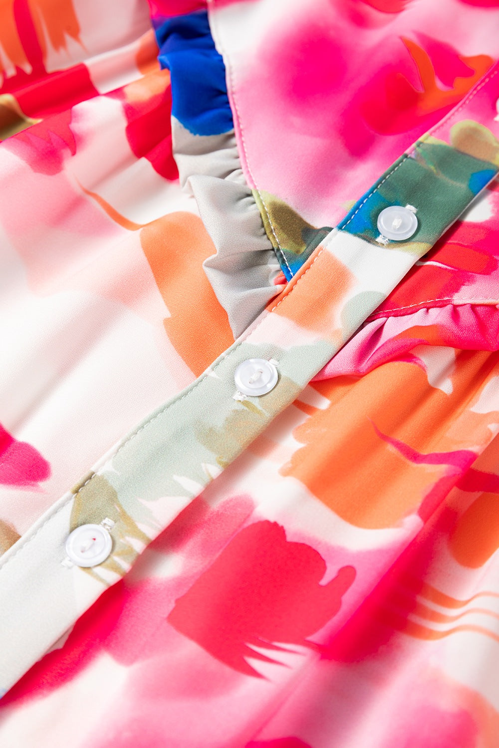 Painterly abstract print blouse with ruffle front and button detail.