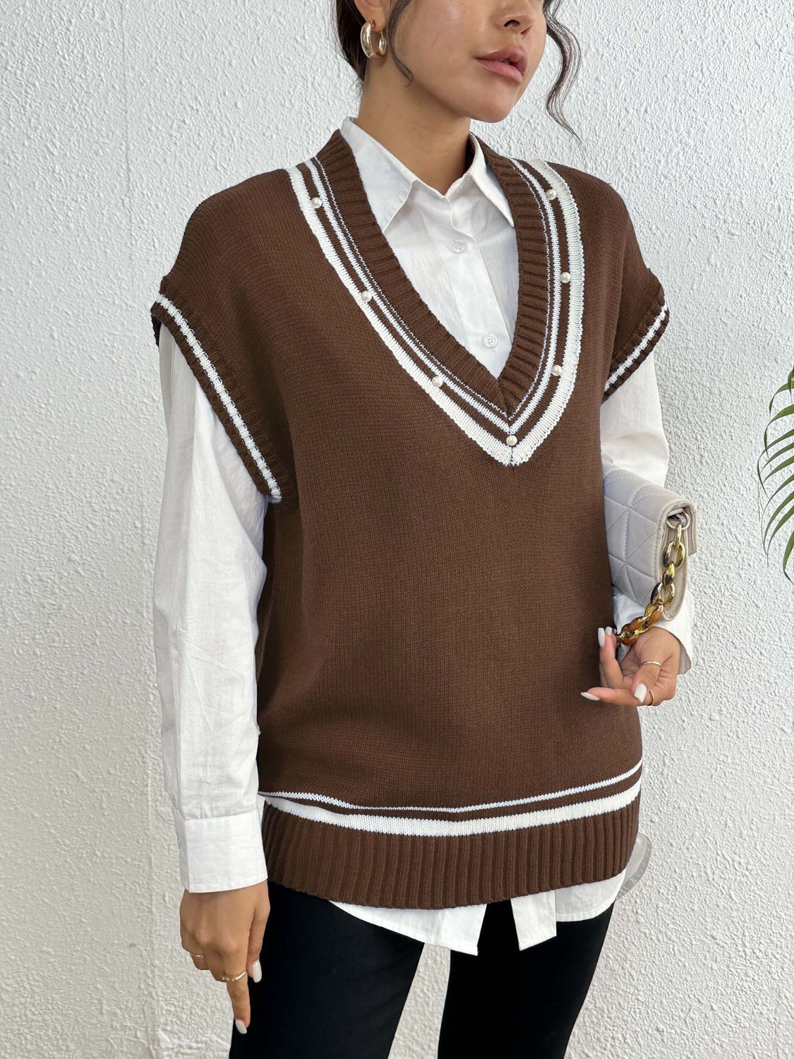 Brown acrylic knit vest with varsity stripes and pearl trim, V-neck, sleeveless.