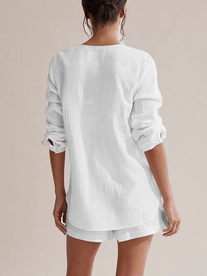 White textured cotton pajama set with button-up shirt and drawstring shorts.